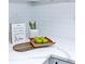 Close-up view of white quartz countertops, decor, and subway tile backsplash at 672 Quillian Ave, Decatur, GA 30032