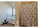 Bathroom featuring a tub, tiled walls, window and separate shower at 879 Tranquil Way, Hampton, GA 30228