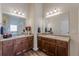 Bathroom with dual sinks and granite counters, wood-look flooring and lots of light at 879 Tranquil Way, Hampton, GA 30228