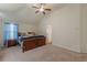 Bedroom featuring carpet, a ceiling fan, neutral paint and vaulted ceiling at 879 Tranquil Way, Hampton, GA 30228
