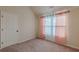 This bedroom features a window, a door and carpeted floors at 879 Tranquil Way, Hampton, GA 30228