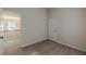 This bedroom features a door and carpeted floors at 879 Tranquil Way, Hampton, GA 30228