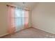 This bedroom features a window, a door and carpeted floors at 879 Tranquil Way, Hampton, GA 30228
