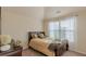 Bedroom featuring neutral tones, carpet, and a large window at 879 Tranquil Way, Hampton, GA 30228