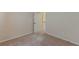 This bedroom features a door and carpeted floors at 879 Tranquil Way, Hampton, GA 30228