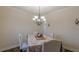 Charming dining room with stylish chandelier, creating a welcoming atmosphere for Gathering and friends at 879 Tranquil Way, Hampton, GA 30228