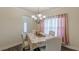 Elegant dining room with chandelier and abundant light, ideal for Gathering dinners or special occasions at 879 Tranquil Way, Hampton, GA 30228