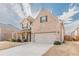 Attractive two-story brick home with a two-car garage, covered porch, and well-manicured lawn at 879 Tranquil Way, Hampton, GA 30228