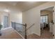 Upstairs hallway with carpet, a staircase and a view of the rooms at 879 Tranquil Way, Hampton, GA 30228