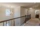 Upstairs hallway with carpet, a staircase and a chandelier at 879 Tranquil Way, Hampton, GA 30228