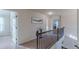 Upstairs hallway featuring decorative railing and natural light at 879 Tranquil Way, Hampton, GA 30228