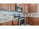 Kitchen with granite countertops, stainless steel appliances, and wooden cabinets, perfect for culinary enthusiasts at 879 Tranquil Way, Hampton, GA 30228