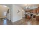 Open kitchen and dining area with stainless steel appliances and an island with bar stools at 879 Tranquil Way, Hampton, GA 30228