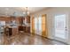 Well-lit kitchen with stainless steel appliances, wooden cabinets, and access to the backyard at 879 Tranquil Way, Hampton, GA 30228