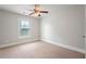 Bright carpeted bedroom with a ceiling fan and natural light offers a comfortable and inviting atmosphere at 140 Ryan Ln, Covington, GA 30014