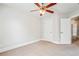 Well-lit carpeted bedroom with a ceiling fan, closet, and paneled door offers comfort and convenience at 140 Ryan Ln, Covington, GA 30014