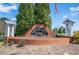 Orchard Park community sign welcomes residents with a lush landscape and a patriotic American flag display at 140 Ryan Ln, Covington, GA 30014