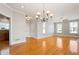 Open-concept dining area with hardwood floors, chandelier, and abundant natural light at 140 Ryan Ln, Covington, GA 30014