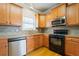 Classic kitchen featuring wooden cabinets, black appliances and a stainless steel dishwasher at 140 Ryan Ln, Covington, GA 30014
