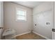 Bright laundry room with tile floors, a window and wire rack shelving provides a functional and organized space at 140 Ryan Ln, Covington, GA 30014