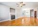 Spacious living room boasts hardwood floors, a ceiling fan, and a charming fireplace at 140 Ryan Ln, Covington, GA 30014