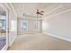 Airy primary bedroom with neutral walls, carpeted floors, tray ceilings and balcony access at 140 Ryan Ln, Covington, GA 30014