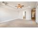 Bright main bedroom featuring tray ceilings, neutral walls, and carpeted floors at 140 Ryan Ln, Covington, GA 30014