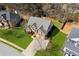 Aerial view of the home surrounded by a green lawn, trees, and neighboring houses at 2688 Stockbridge Way, Dacula, GA 30019