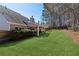 Lush backyard with a covered patio, ideal for entertaining and relaxing in a serene outdoor setting at 2688 Stockbridge Way, Dacula, GA 30019