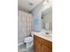 Well-lit bathroom with vanity, sink, toilet, and a shower with patterned curtain at 2688 Stockbridge Way, Dacula, GA 30019