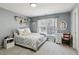 Cozy bedroom featuring a double bed, stylish decor, and natural light from a window at 2688 Stockbridge Way, Dacula, GA 30019
