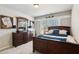 Inviting bedroom with dark wood furniture, including a dresser and a baseball-themed decor at 2688 Stockbridge Way, Dacula, GA 30019