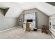 Versatile bonus room with a large window, desk setup, and neutral carpet at 2688 Stockbridge Way, Dacula, GA 30019