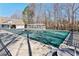 Community pool covered for the off-season, surrounded by seating and a pergola for shade at 2688 Stockbridge Way, Dacula, GA 30019