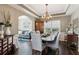 Elegant dining room with tray ceiling and chandelier; open to the living room, perfect for entertaining at 2688 Stockbridge Way, Dacula, GA 30019