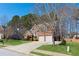 Two story brick home featuring an attached two car garage and a green lawn at 2688 Stockbridge Way, Dacula, GA 30019