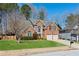 Charming brick home with a well-manicured lawn, a two-car garage, and an arched window at 2688 Stockbridge Way, Dacula, GA 30019