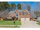 Charming brick home with a well-manicured lawn and two-car garage at 2688 Stockbridge Way, Dacula, GA 30019