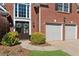 Close up of the house with double doors, an attached garage, and well-maintained landscaping at 2688 Stockbridge Way, Dacula, GA 30019