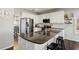 Modern kitchen with white cabinetry, stainless steel appliances, granite countertops and kitchen island at 2688 Stockbridge Way, Dacula, GA 30019