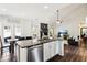 Open-concept kitchen view to the living room. Offers stainless appliances, great lighting and modern design at 2688 Stockbridge Way, Dacula, GA 30019