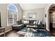 Comfortable living room with a large window and vaulted ceilings offering an abundance of natural light at 2688 Stockbridge Way, Dacula, GA 30019