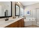 Luxurious main bathroom featuring double sinks, a soaking tub, and a separate shower at 2688 Stockbridge Way, Dacula, GA 30019
