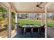 Spacious covered patio with outdoor dining area overlooking a manicured lawn at 2688 Stockbridge Way, Dacula, GA 30019