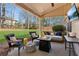 Inviting covered patio with a fire pit, lounge seating, and mounted TV at 2688 Stockbridge Way, Dacula, GA 30019