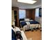 Basement bedroom with tiled floor, wood paneled walls, and comfortable furnishings at 496 Elizabeth Sw Ln, Mableton, GA 30126