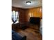 Cozy bedroom with wood-paneled walls, hardwood floors, and a window for natural light at 496 Elizabeth Sw Ln, Mableton, GA 30126
