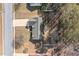 Birds-eye view of a single Gathering home featuring its roof and driveway, surrounded by trees and well-kept lawns at 55 Vintage Dr, Covington, GA 30014