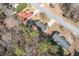 An aerial view showcases a house with a well-manicured lawn and mature trees in a quiet neighborhood at 55 Vintage Dr, Covington, GA 30014