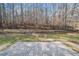 A lovely backyard featuring a brick patio and a retaining wall, all situated near a wooded area at 55 Vintage Dr, Covington, GA 30014
